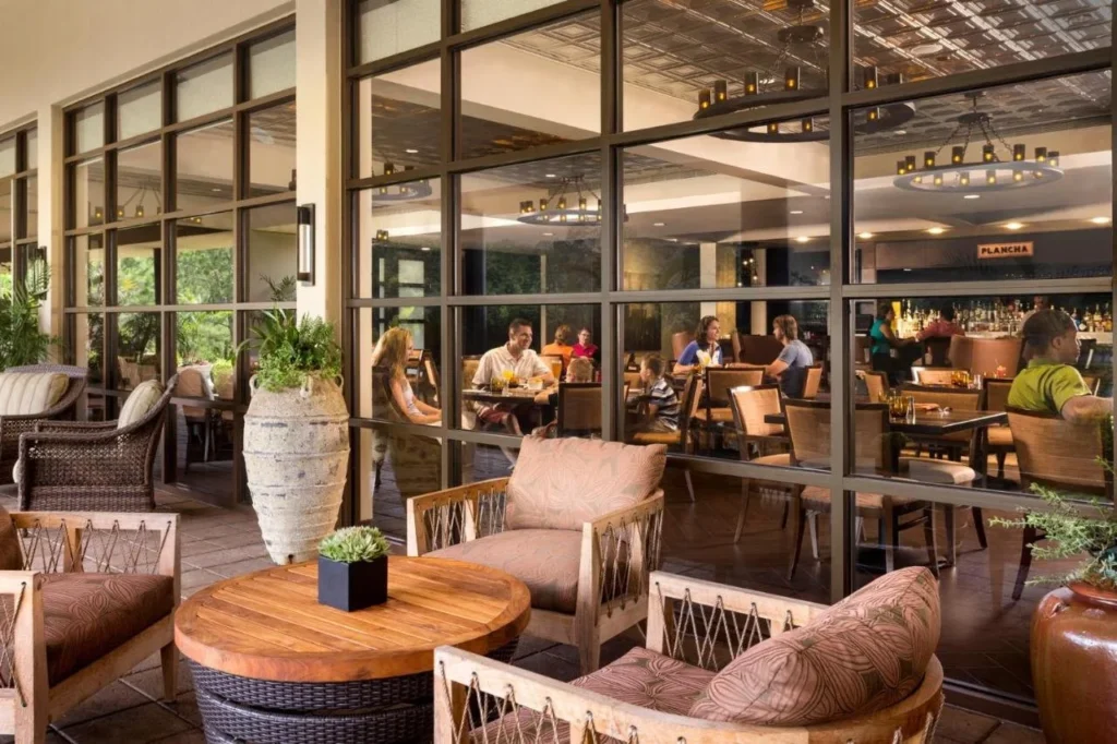 Covered terrace seating outside Plancha restaurant at Four Seasons Resort Orlando