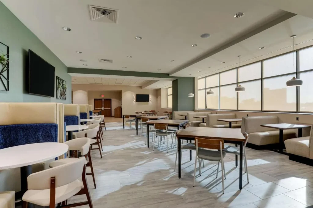 Dining room with blue booths, banquettes and wooden tables at Drury Plaza Hotel Orlando