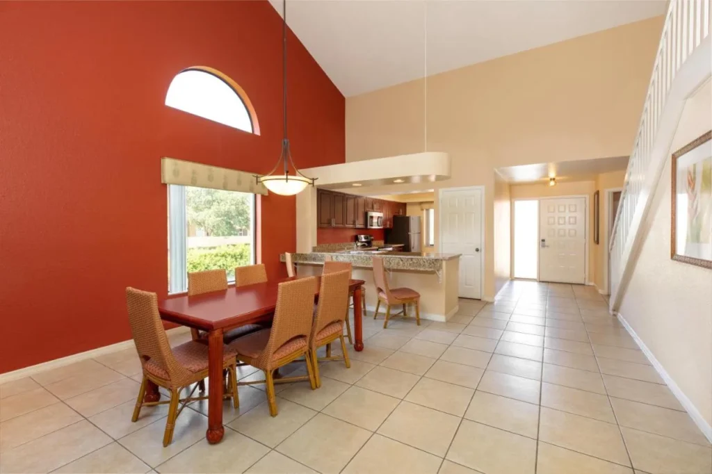 Double-height dining room with table for six beside the kitchen in a Westgate Vacation Villas loft villa