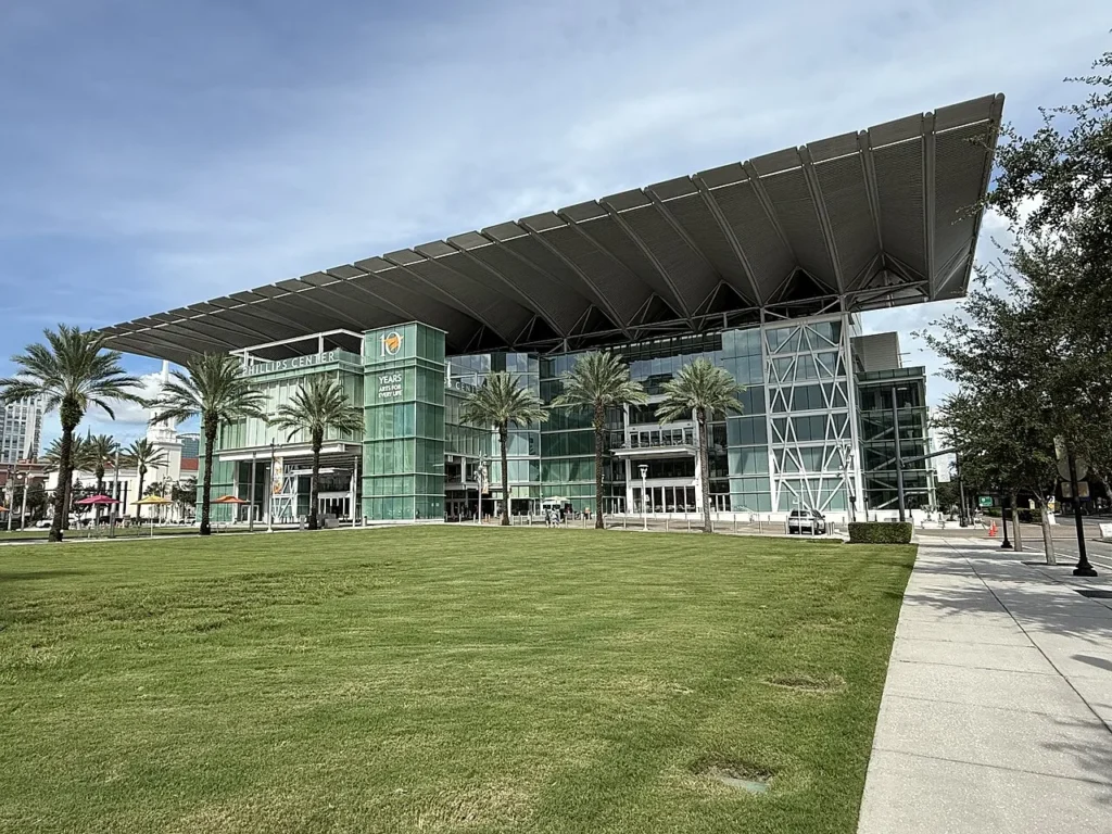 Dr. Phillips Center for the Performing Arts with its canopy roof, palm trees and lawn