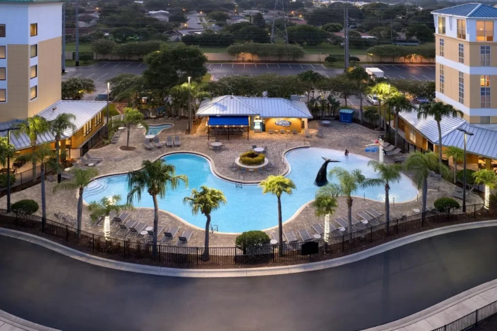 Dusk aerial of the pool, whale-tail fountain and Splash bar at SpringHill Suites Orlando at SeaWorld