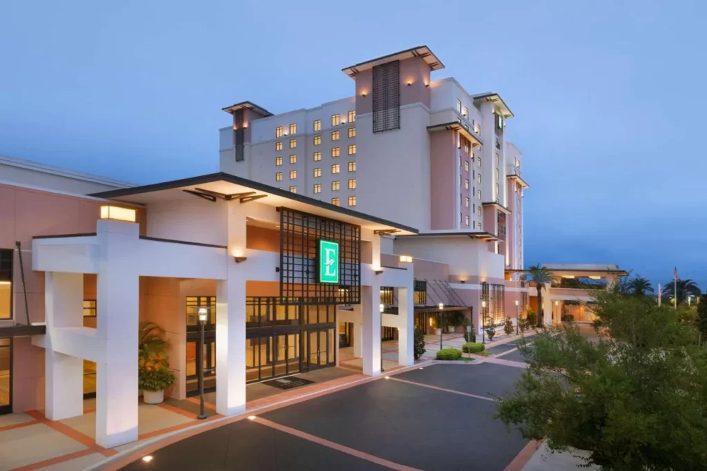 Entrance canopy and pink tower at dusk at Embassy Suites Lake Buena Vista South