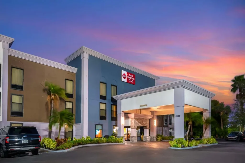 Entrance canopy and sign at sunset at Best Western Plus Universal Inn