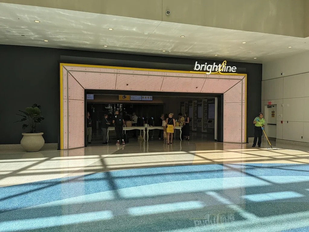 Entrance to the Brightline train station inside Orlando International Airport with ticket machines