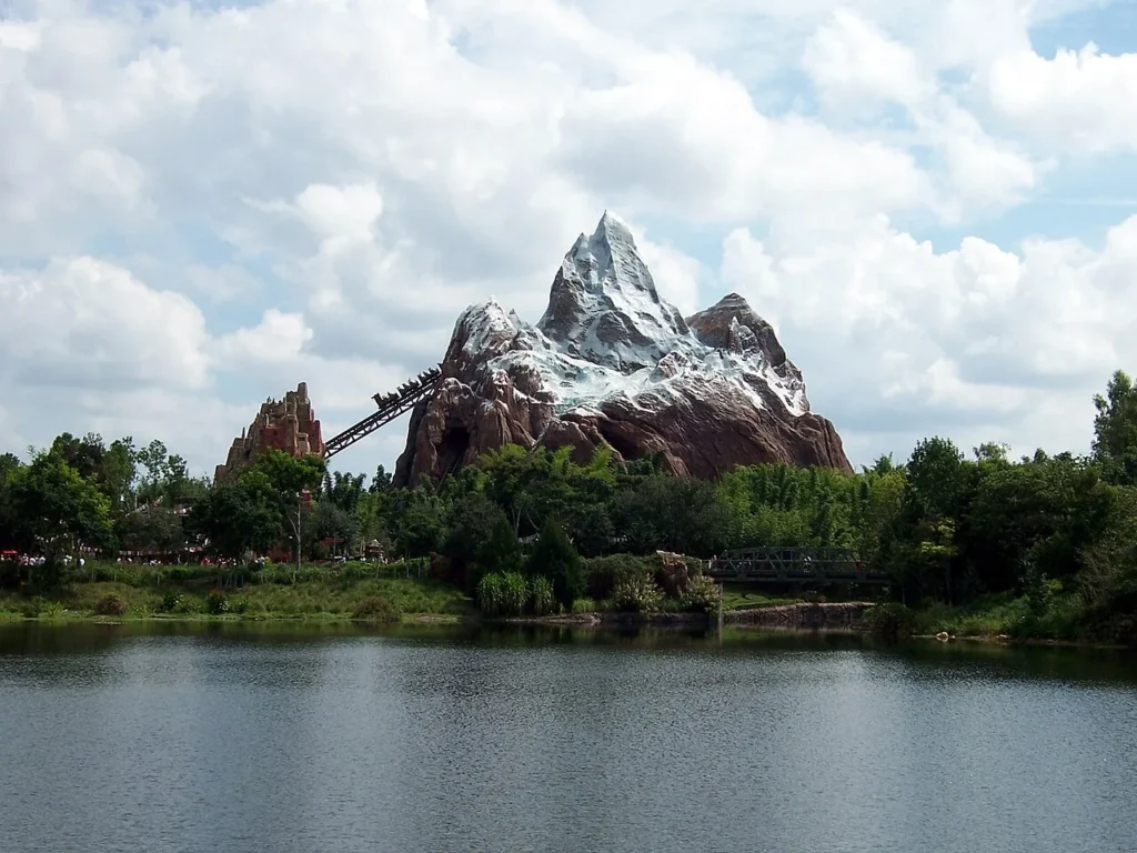 Expedition Everest's snowy mountain and coaster lift rising above Discovery River at Disney's Animal Kingdom