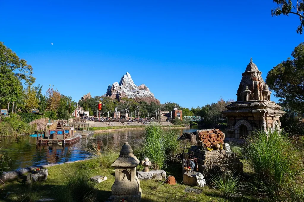 Expedition Everest's snowy peak beyond the river and stone shrines in Asia, Disney's Animal Kingdom