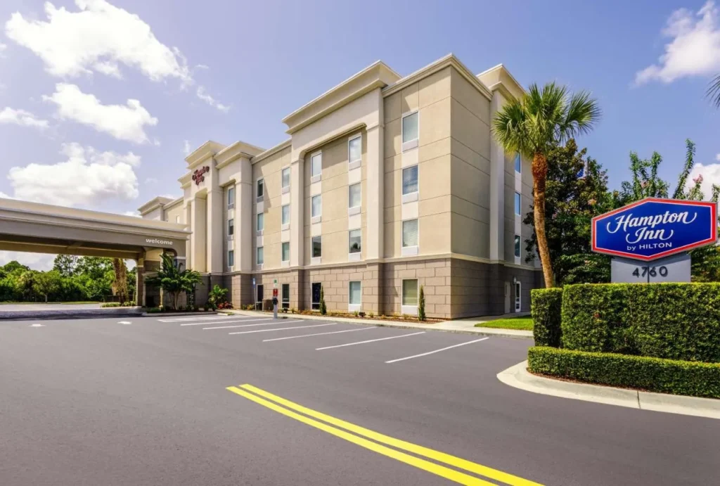 Exterior and entrance sign of Hampton Inn Titusville I-95 Kennedy Space Center on a sunny day