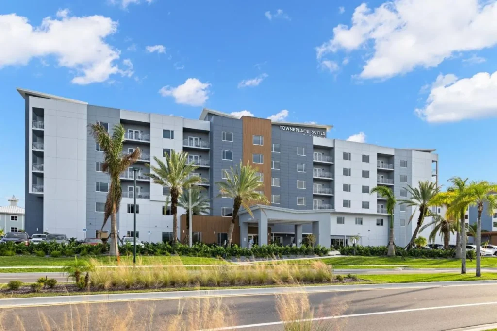 Exterior of TownePlace Suites Cape Canaveral Cocoa Beach with balconies and palm trees