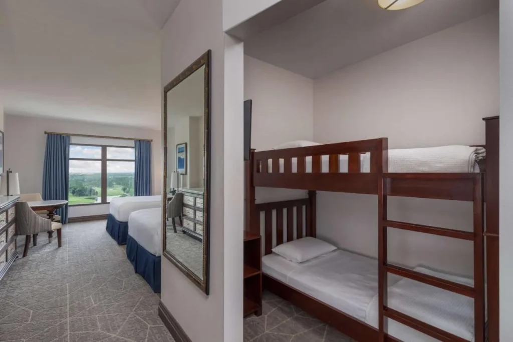 Family Bunk room with bunk beds and two queen beds at Wyndham Grand Bonnet Creek