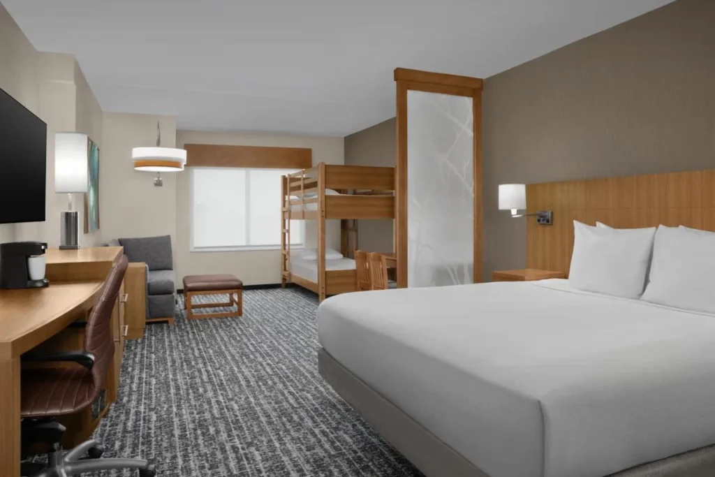 Family room with a king bed and kids bunk beds at Hyatt Place Orlando/Lake Buena Vista