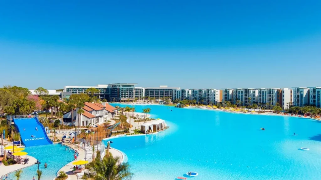 Family waterslide pool beside Evermore Bay lagoon with the Flats behind at Evermore Orlando Resort