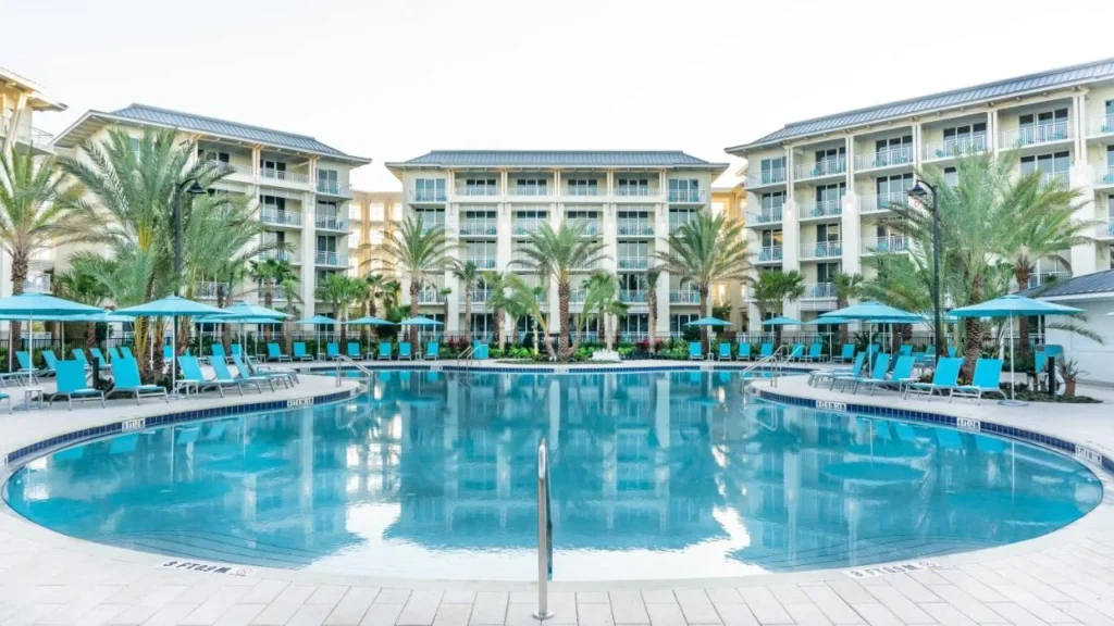 Fins Up Beach Club pool with turquoise loungers below hotel buildings at Margaritaville Resort Orlando