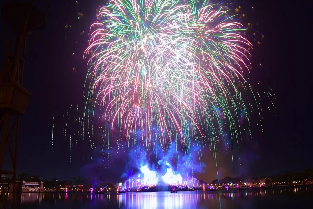 Fireworks and lit fountains above World Showcase Lagoon during Luminous The Symphony of Us at EPCOT