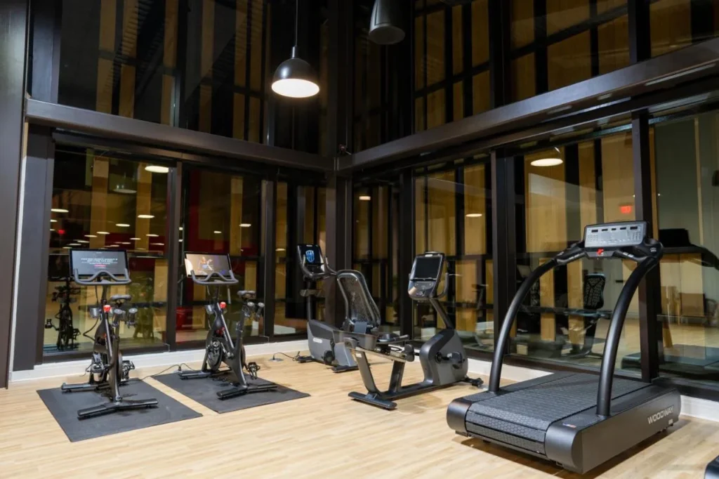 Fitness center with Peloton bikes and a Woodway treadmill at Evermore Orlando Resort