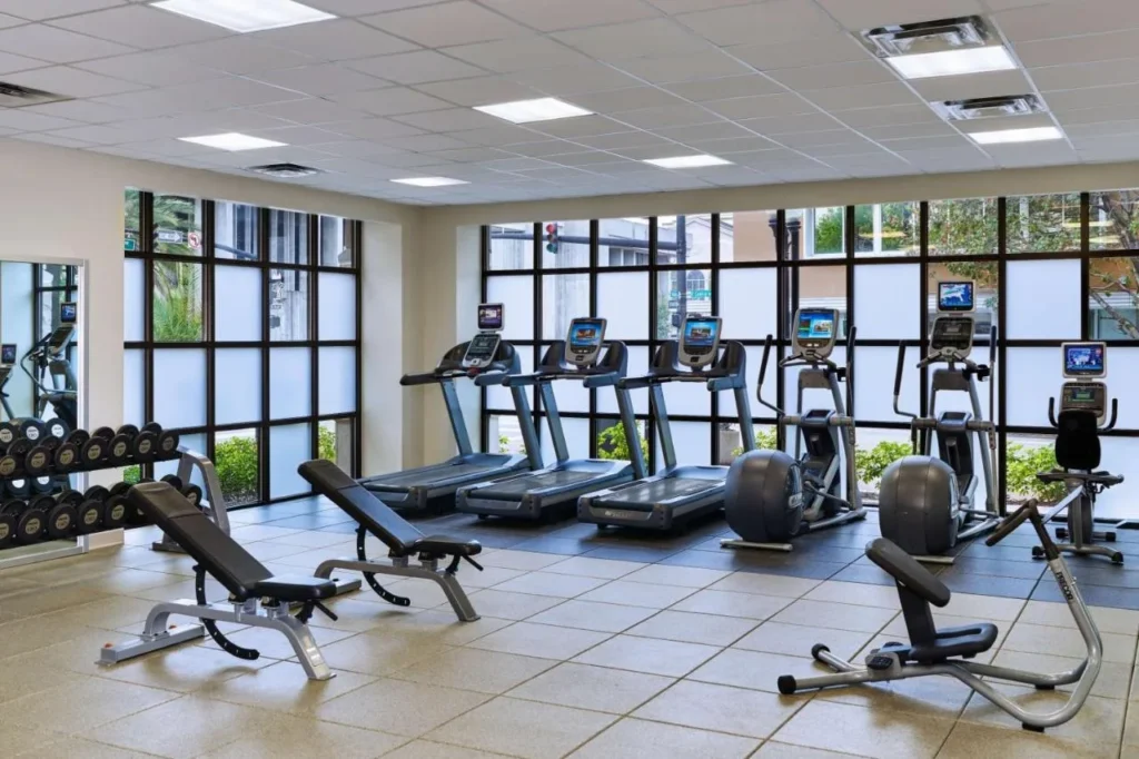 Fitness center with treadmills, bikes and free weights at Embassy Suites Orlando Downtown