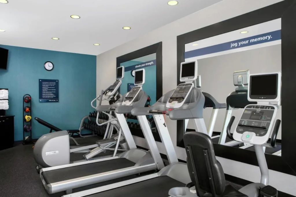 Fitness center with treadmills, elliptical trainers and dumbbells at Hampton Inn Orlando/Lake Buena Vista