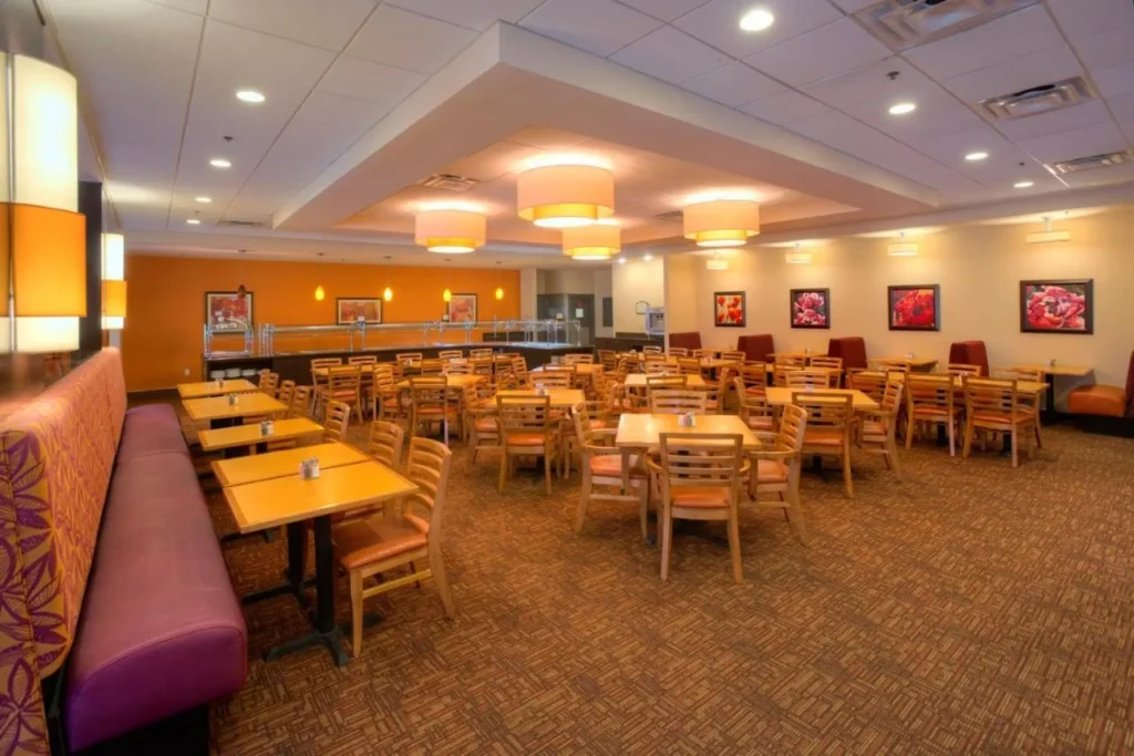 Fountain View Cafe dining room with tables and buffet line at Rosen Inn International