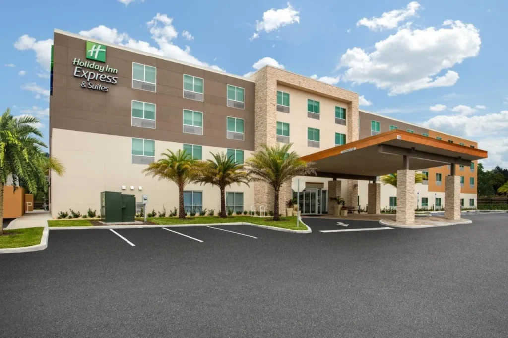 Four-story exterior and covered entrance of the Holiday Inn Express and Suites Deland South