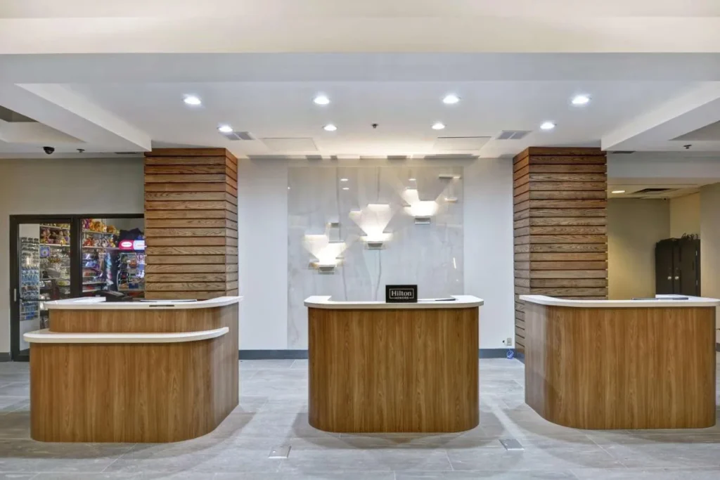 Front desk pods with wood panels in the lobby at Embassy Suites Orlando Downtown