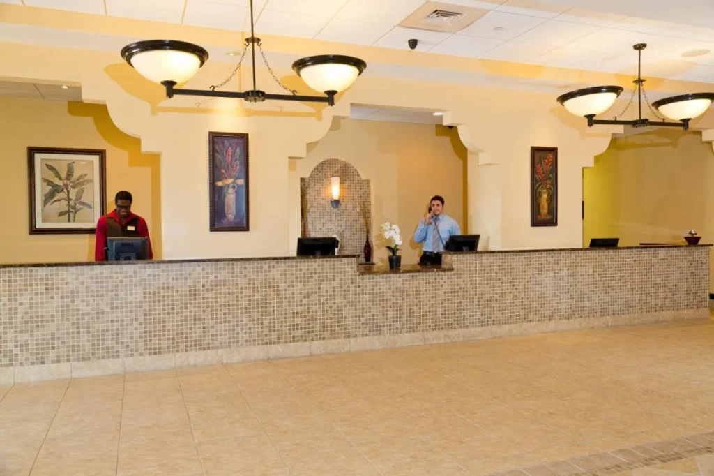 Front desk with a tiled counter and pendant lights at Lake Buena Vista Resort Village