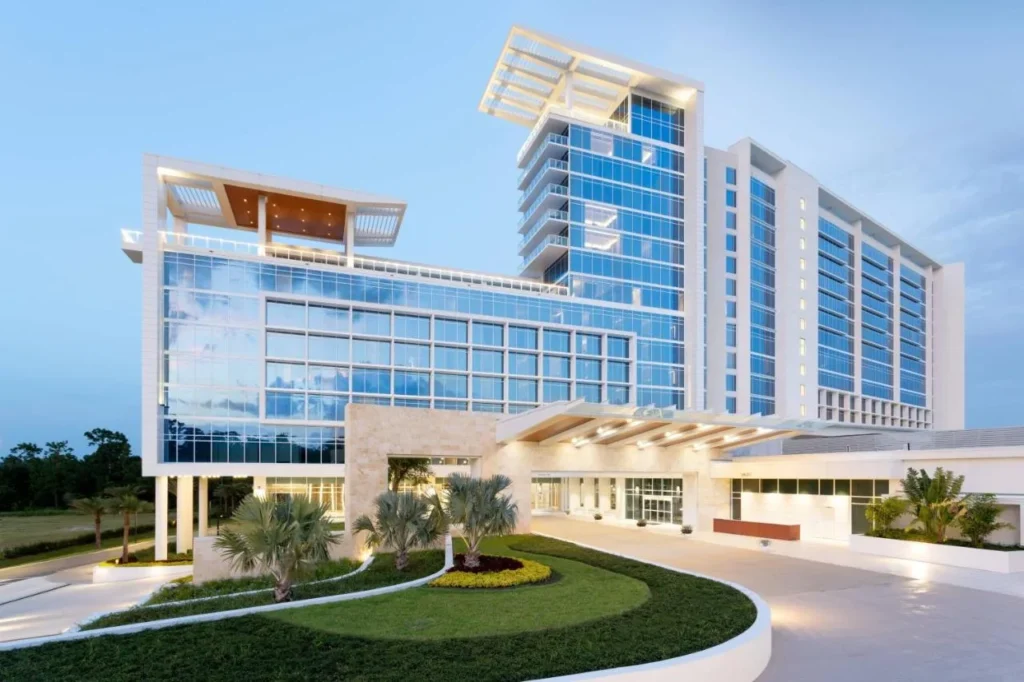 Front entrance with porte-cochere and circular lawn below the JW Marriott Orlando Bonnet Creek tower