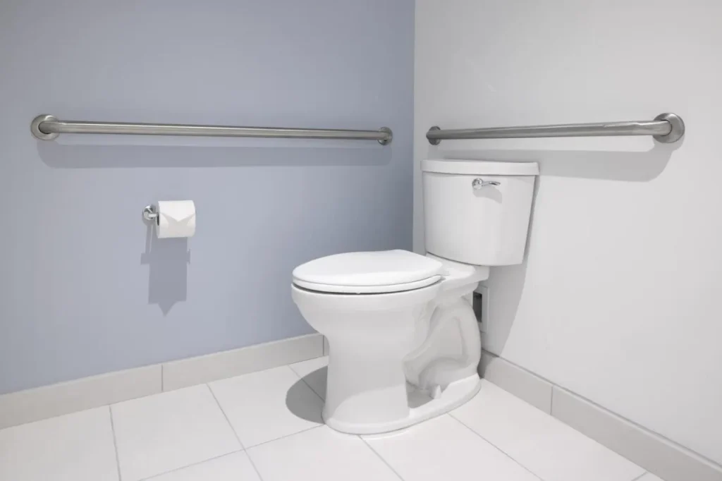 Grab bars beside the toilet in an accessible bathroom at Universal Stella Nova Resort