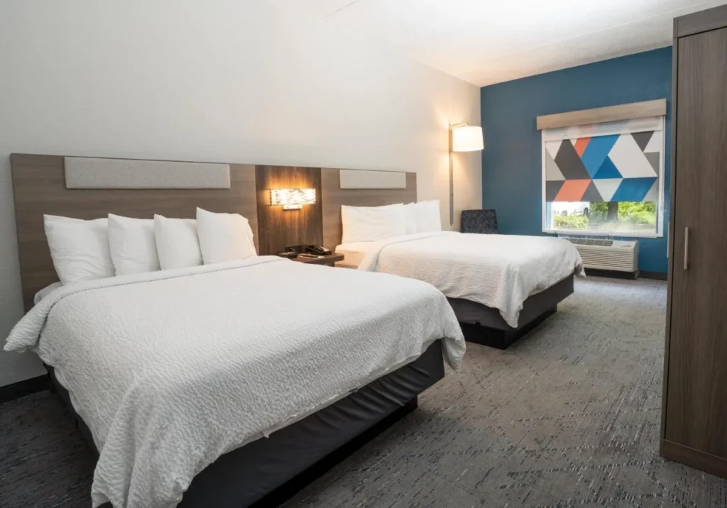 Guest room with two beds and a blue accent wall at Holiday Inn Express Orange City