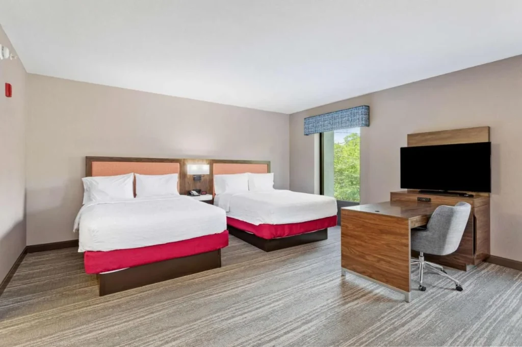 Guest room with two queen beds, desk and TV at Hampton Inn & Suites Orlando-Apopka