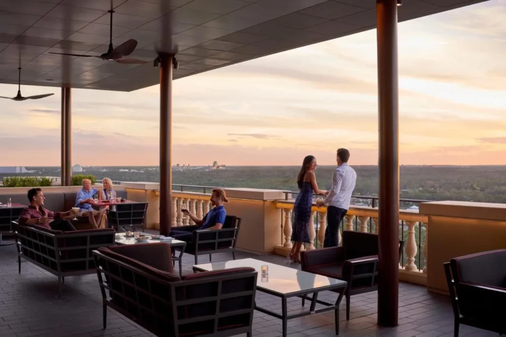 Guests on a rooftop terrace at sunset at Four Seasons Resort Orlando