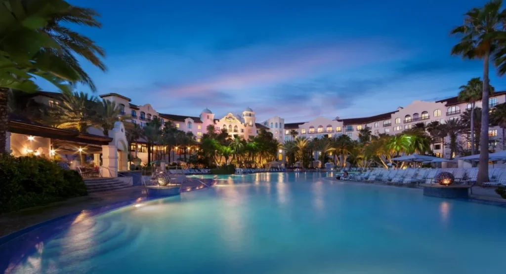 Hard Rock Hotel at Universal Orlando pool and Spanish-style buildings lit up at dusk