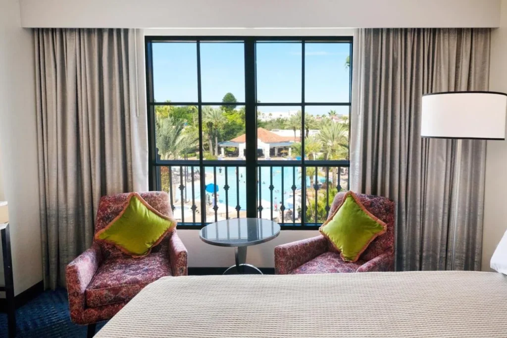 Hard Rock Hotel Orlando room with two armchairs facing a window that overlooks the pool