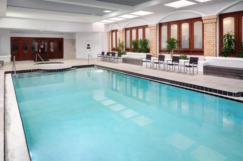 Heated indoor pool and whirlpool with brick columns at Embassy Suites Orlando North