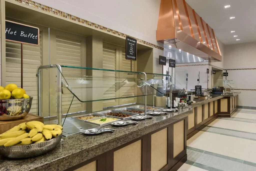 Hot breakfast buffet line with fruit and cook-to-order stations at Embassy Suites LBV South