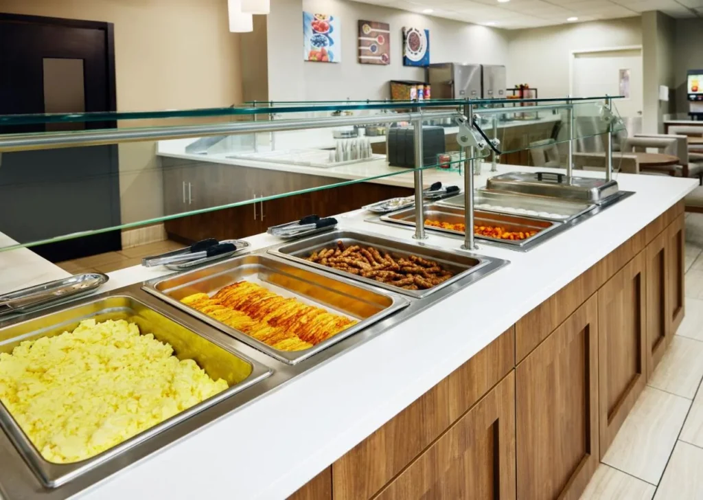 Hot breakfast buffet with scrambled eggs, bacon and sausage at Staybridge Suites Orlando Royale Parc