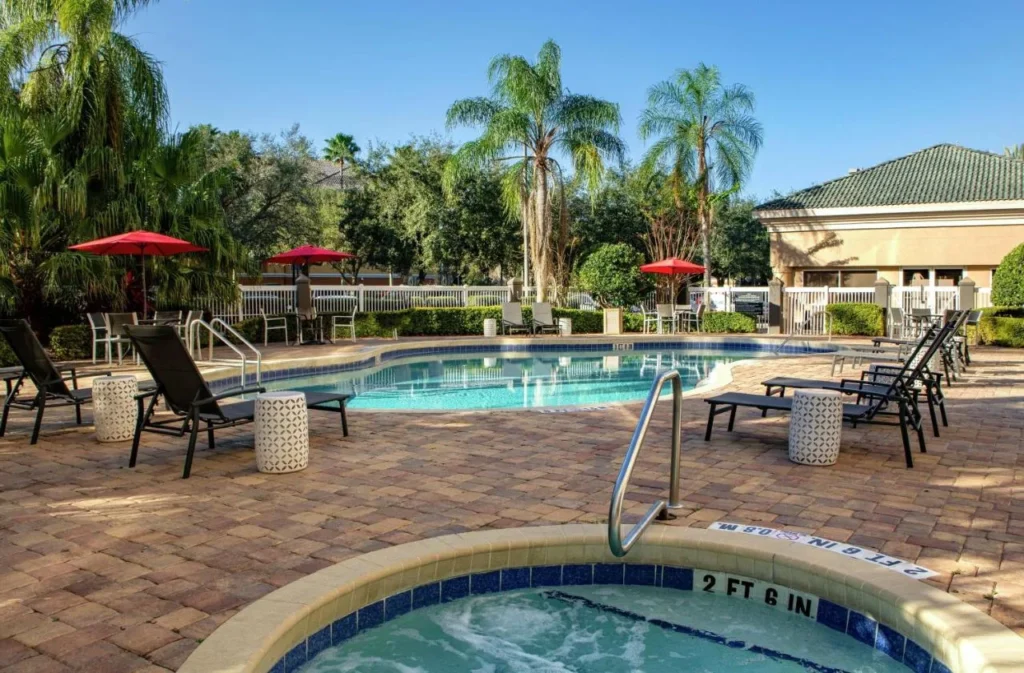 Hot tub beside the outdoor pool and loungers at Hampton Inn Orlando/Lake Buena Vista