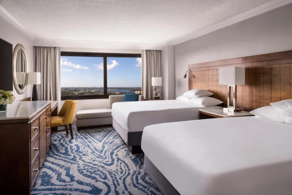 Hyatt Regency Orlando guest room with two queen beds, sofa and a high-floor window view