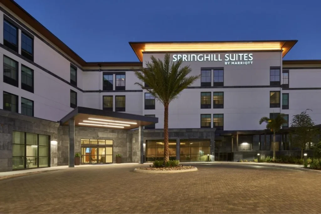 Entrada iluminada y palmera al atardecer en SpringHill Suites by Marriott Winter Park