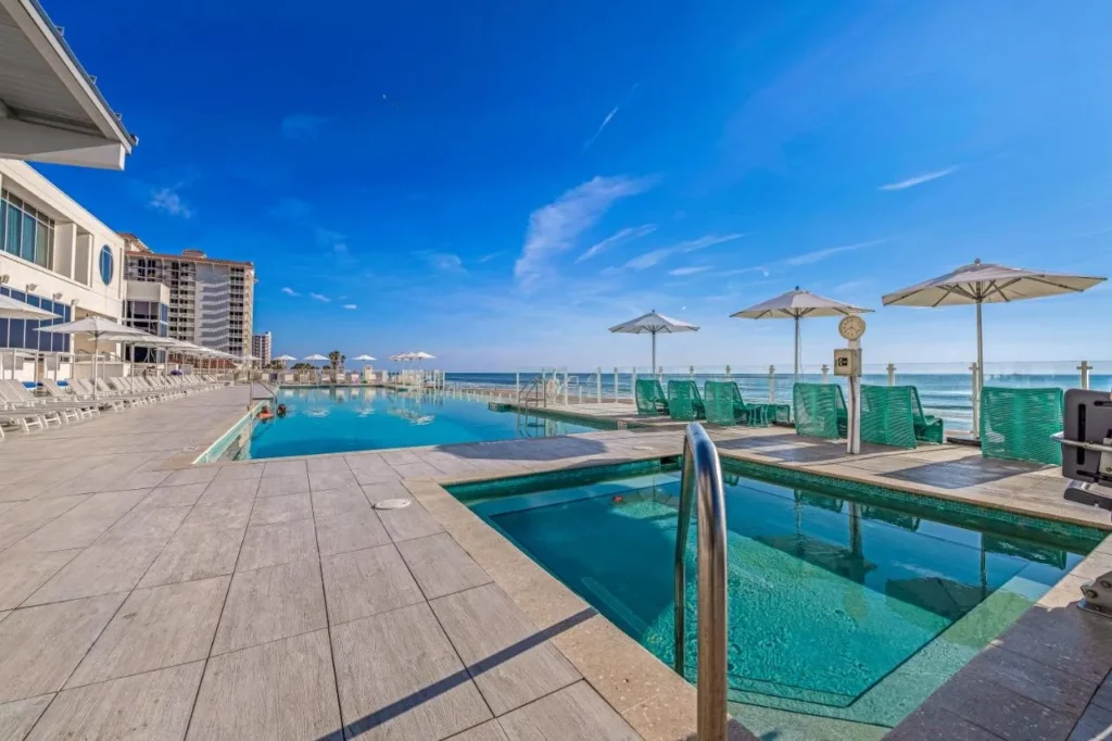 Infinity-edge pool and hot tub facing the ocean at Daytona Grande Oceanfront Resort