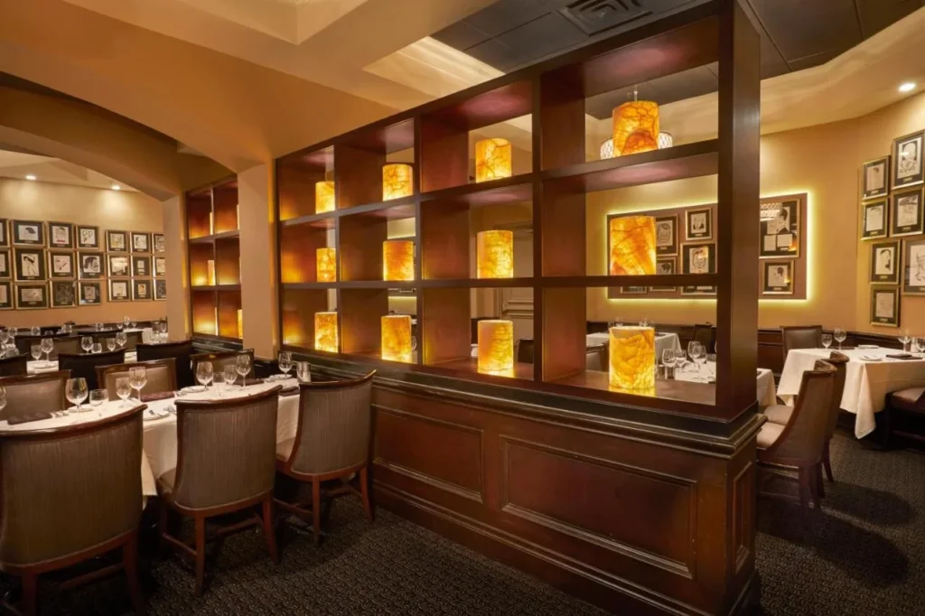 Jack's Place steakhouse dining room with framed celebrity caricatures at Rosen Plaza Hotel