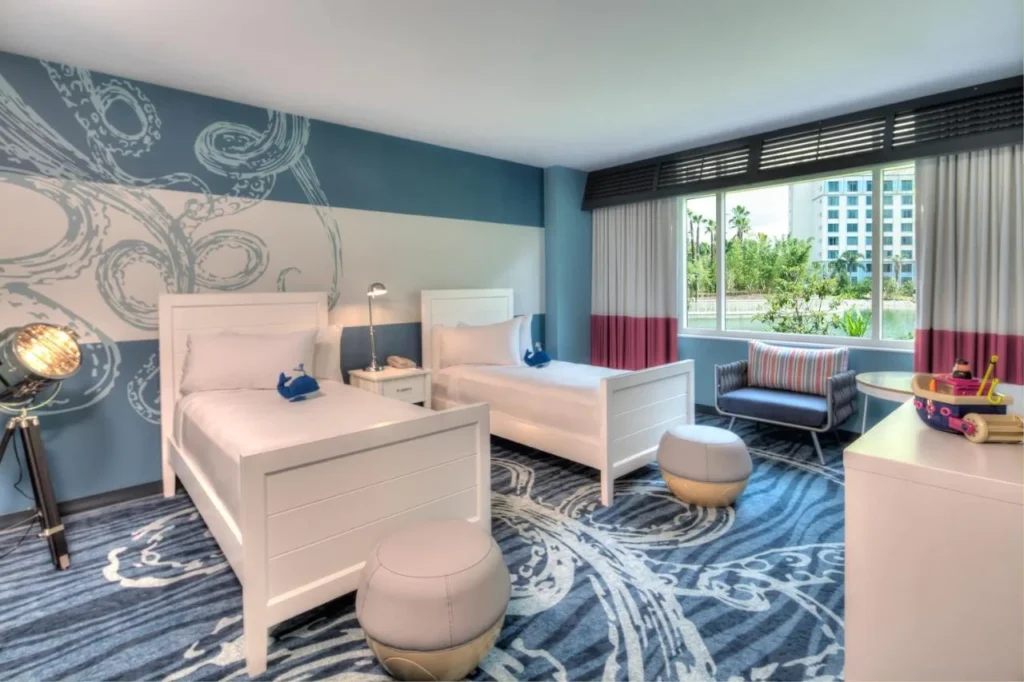 Kids' room with two beds and an octopus wall mural at Loews Sapphire Falls Resort