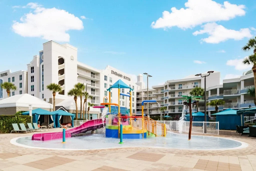 Kids' splash pad with a pink slide at Embassy Suites Orlando Lake Buena Vista Resort