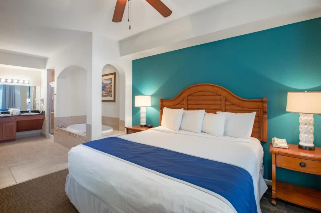King bedroom with a teal wall and jetted tub alcove at Lake Buena Vista Resort Village
