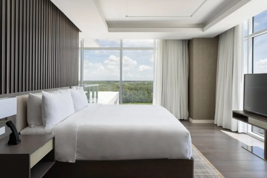 King bedroom with floor-to-ceiling windows at JW Marriott Orlando Bonnet Creek