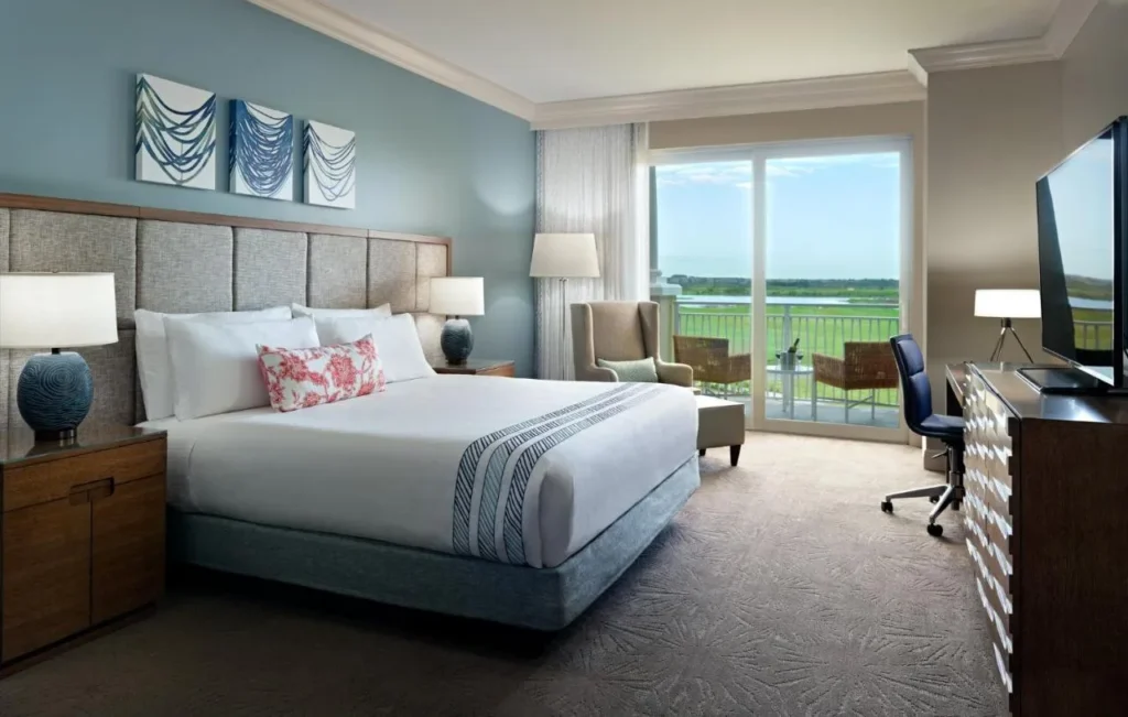 King room with a balcony looking out over green grounds at Omni Orlando Resort at ChampionsGate