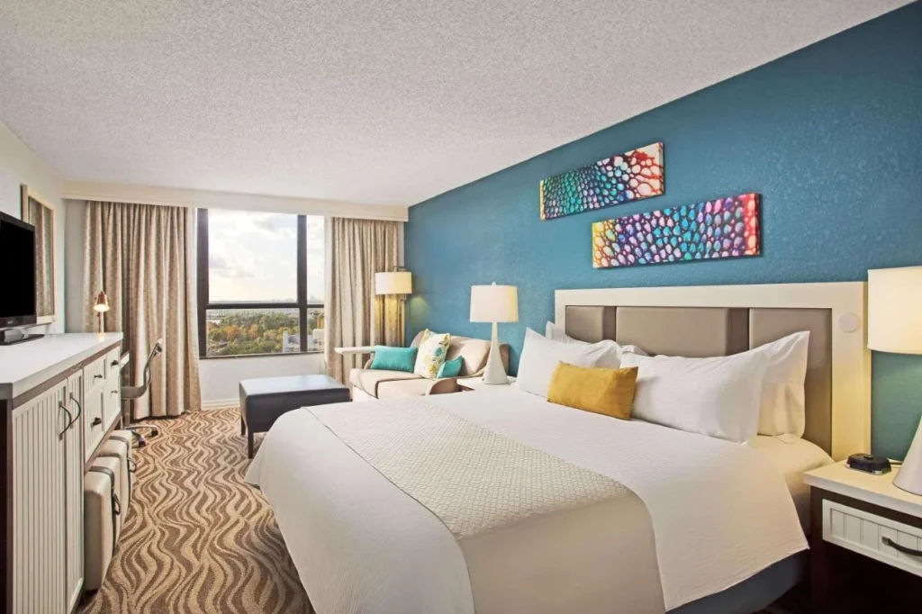 King room with a sofa and a teal accent wall at Wyndham Lake Buena Vista