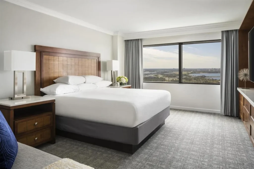 King room with a wide window, desk and gray carpet at Hyatt Regency Orlando