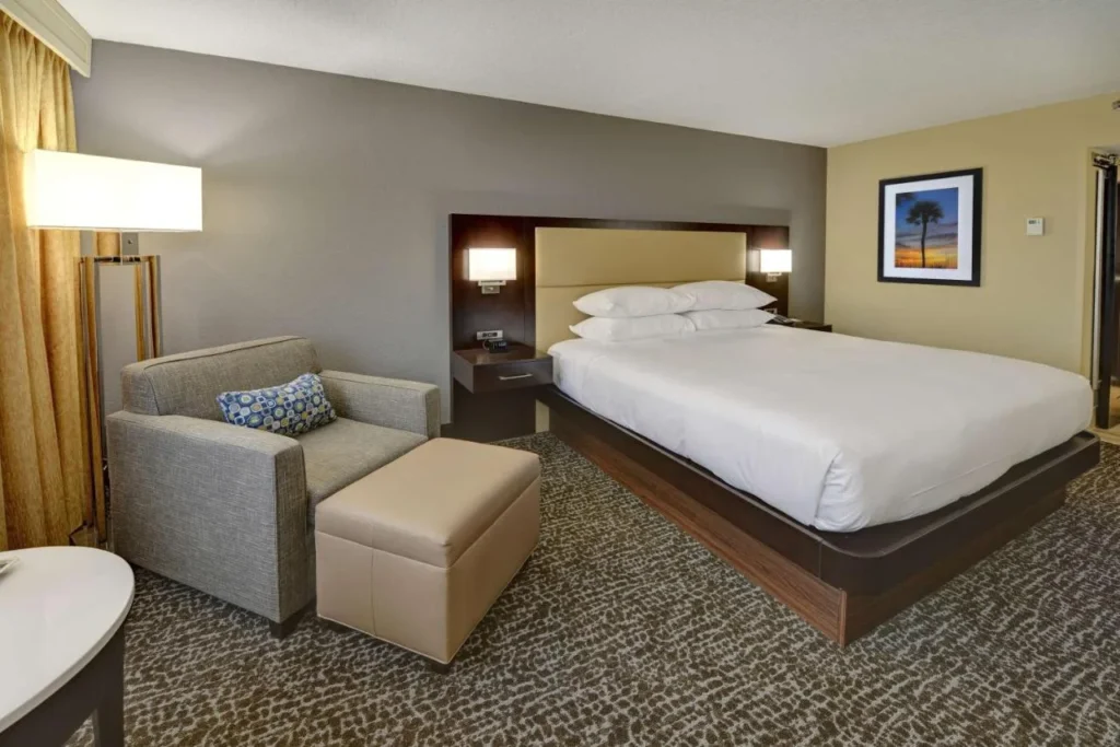 King room with an armchair and ottoman at Hilton Orlando/Altamonte Springs