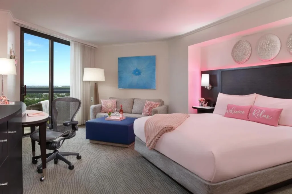 King room con iluminaci&oacute;n rosa y puerta de balc&oacute;n en el Hilton Orlando Buena Vista Palace