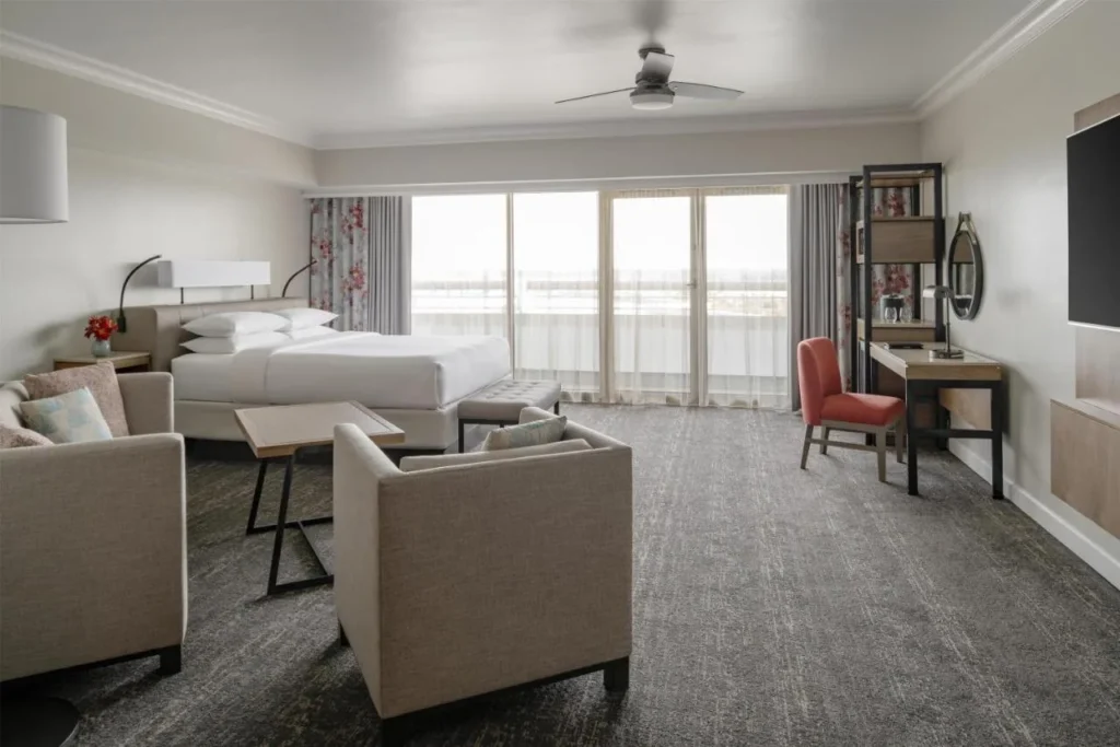 King room with sitting area and floor-to-ceiling glass doors at Hyatt Regency Orlando International Airport