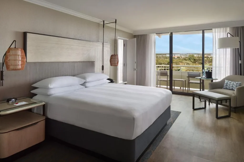 King room with sliding doors to a balcony at Orlando World Center Marriott